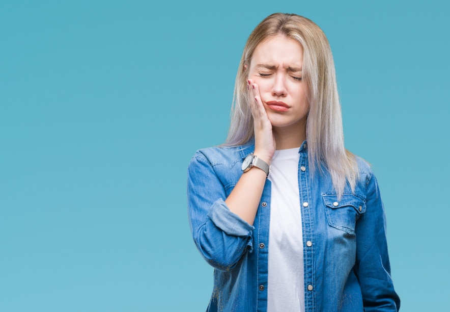 Photo of a Girl touching her mouth with hand due to toothache