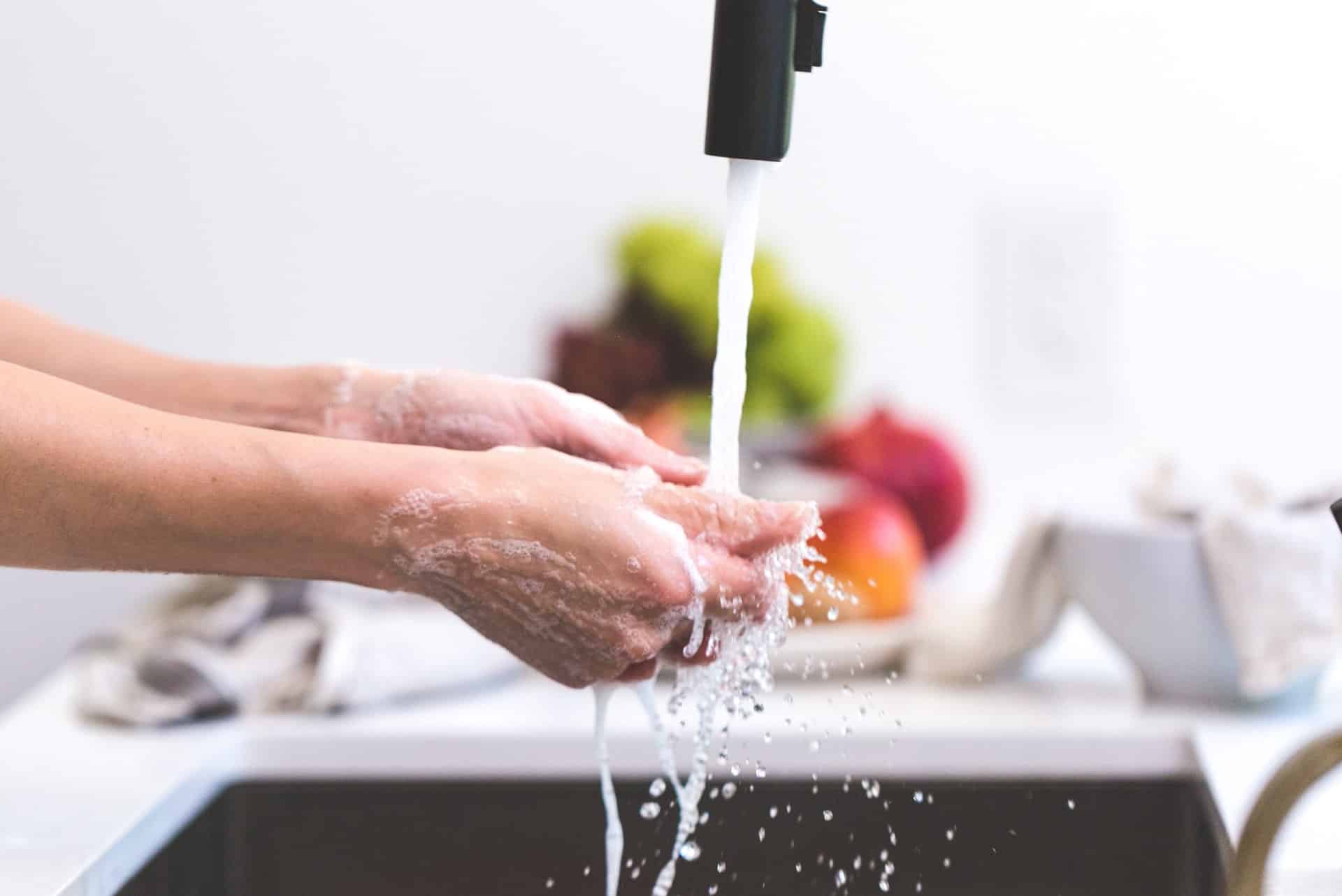 photo of women washing hands thoroughly fulfilling coronavirus safety precautions