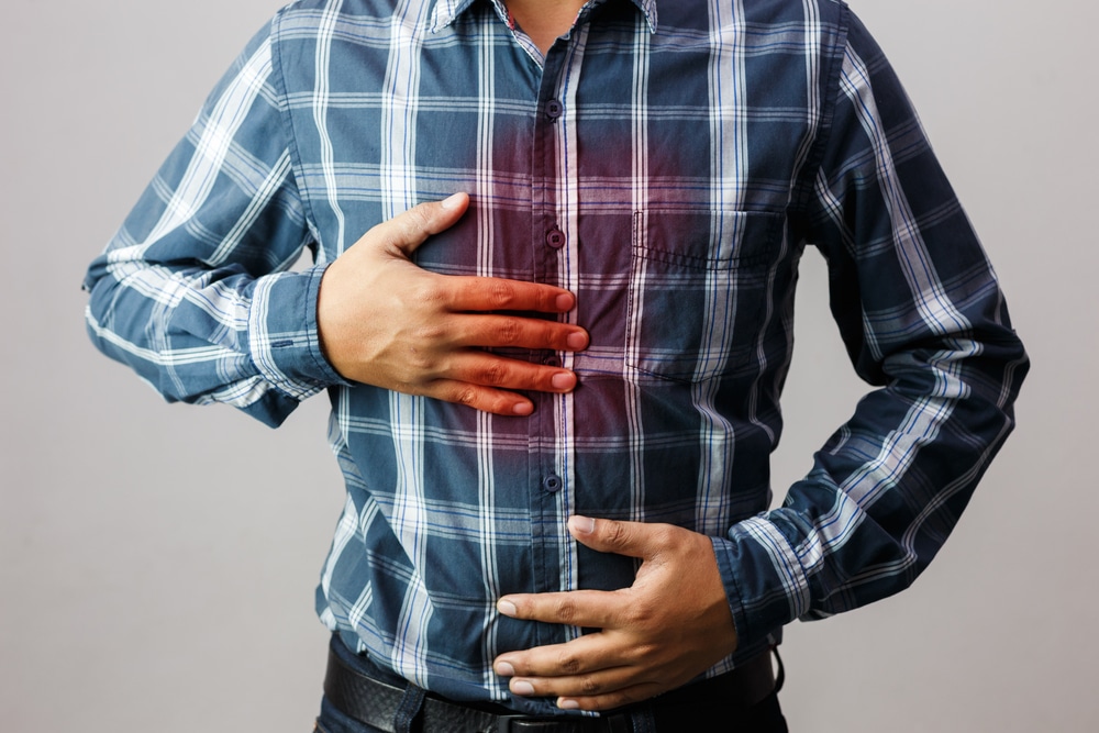 Men having heartburn in the middle of the chest due to acid reflux